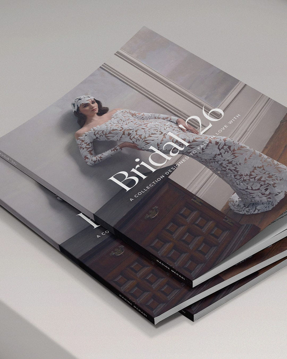 Stack of books with a model in a wedding dress on the cover, titled 'Bridal 26'.