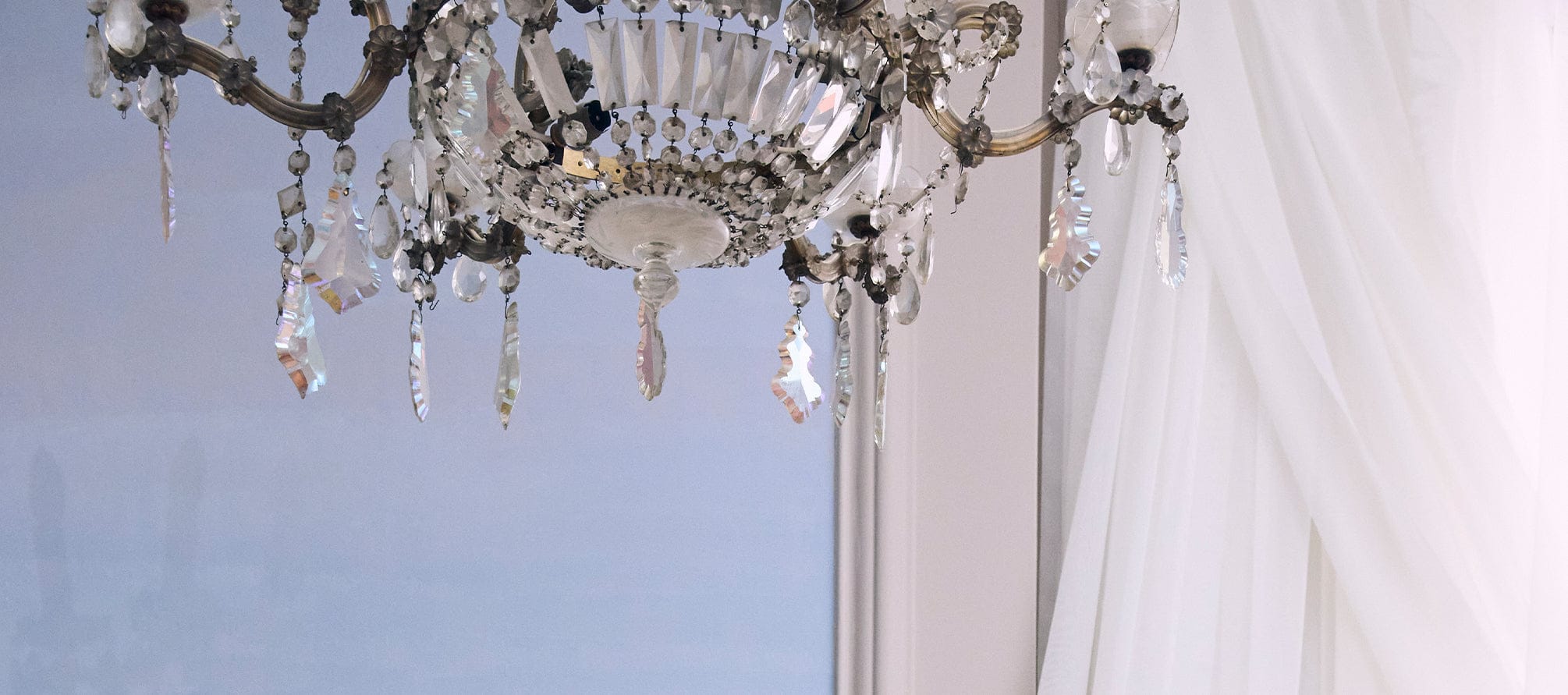 Close-up of a crystal chandelier with a blurred background