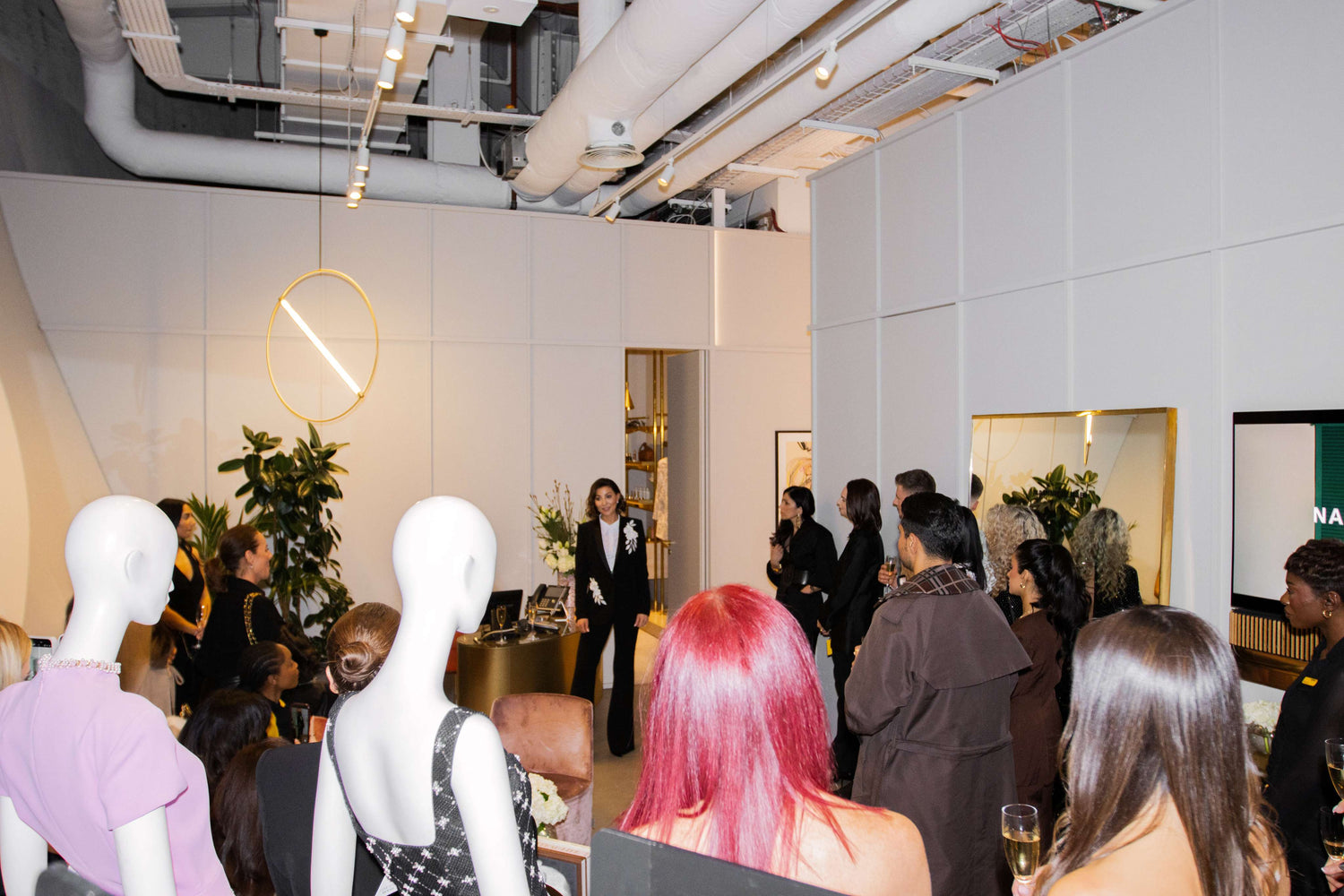Event or gathering with people and mannequins in a modern indoor setting