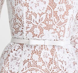 Close-up of a white lace dress with floral patterns