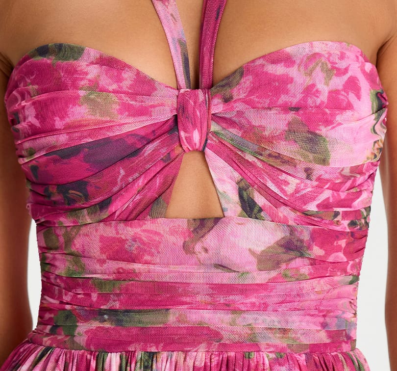 Close-up of a pink floral dress with a cut-out design.