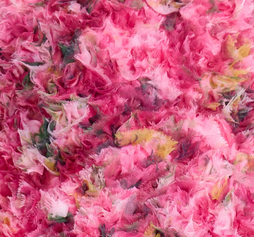 Close-up of pink fabric with frayed edges