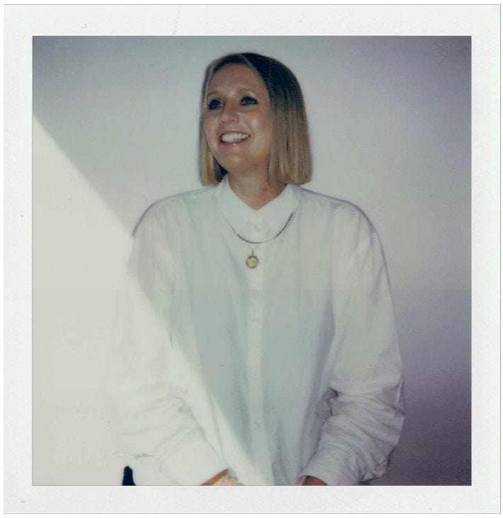 Person wearing a white shirt against a plain background